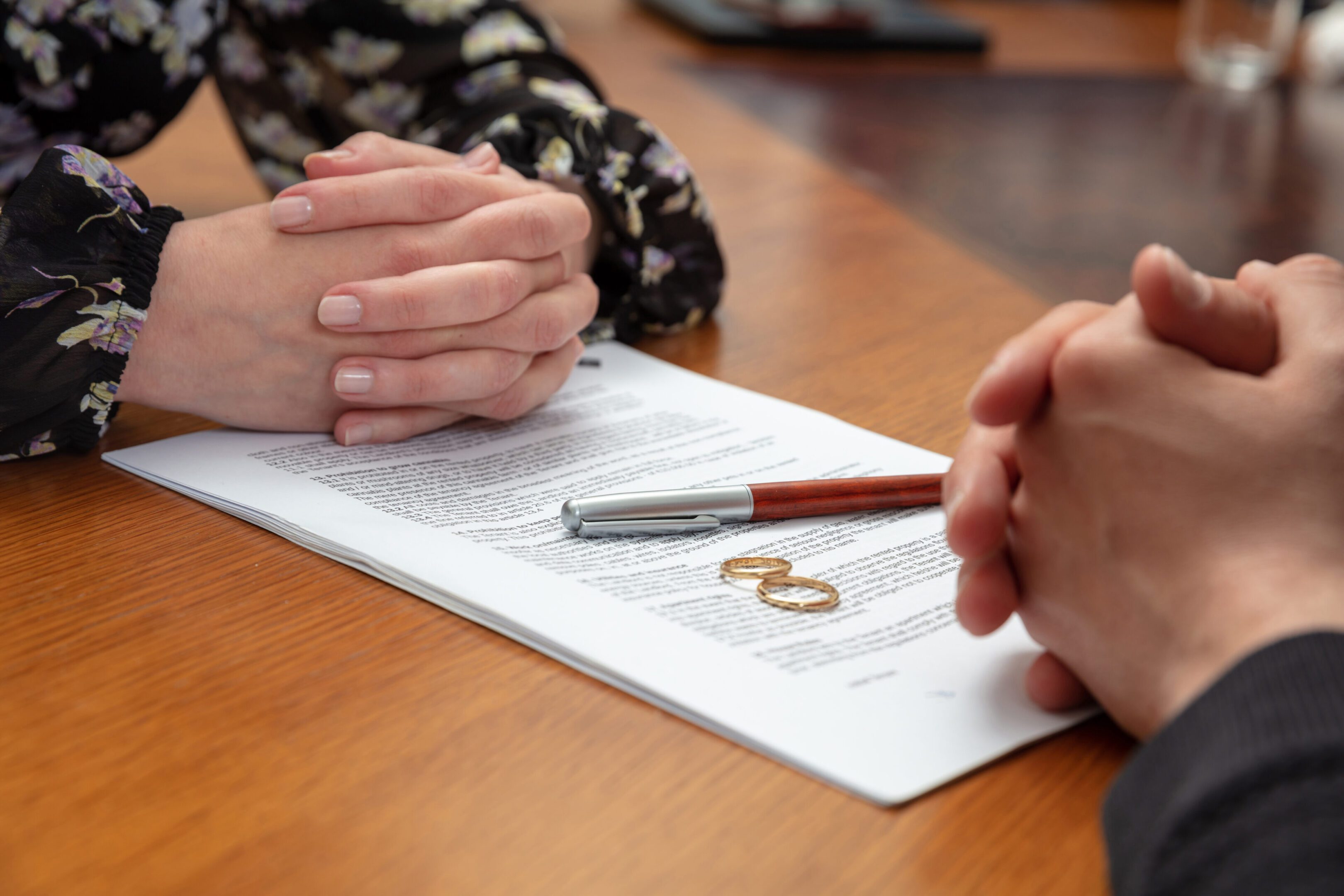 A couple of people sitting at a table with papers