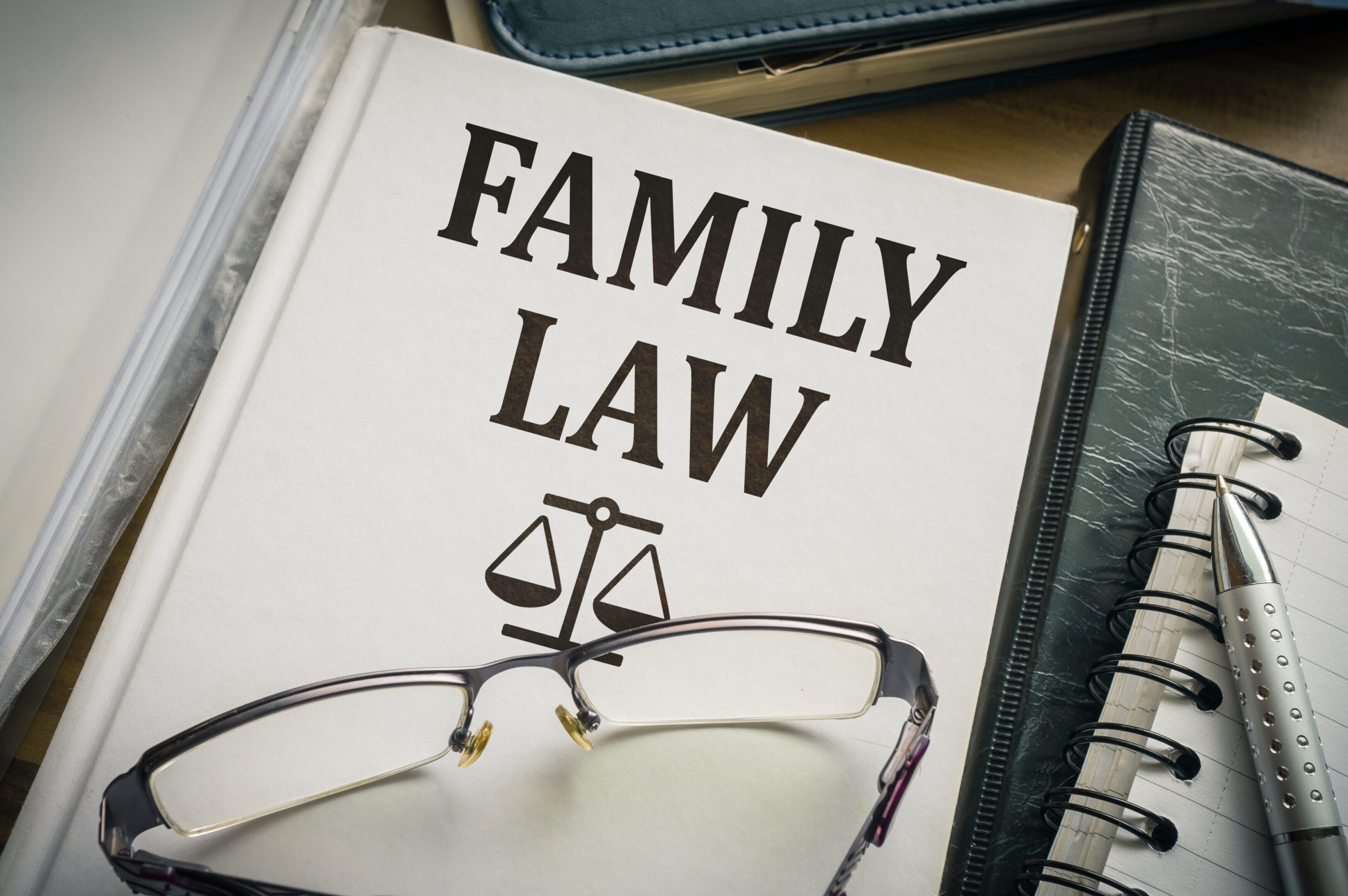 A book about family law with glasses and a pair of eye glasses.